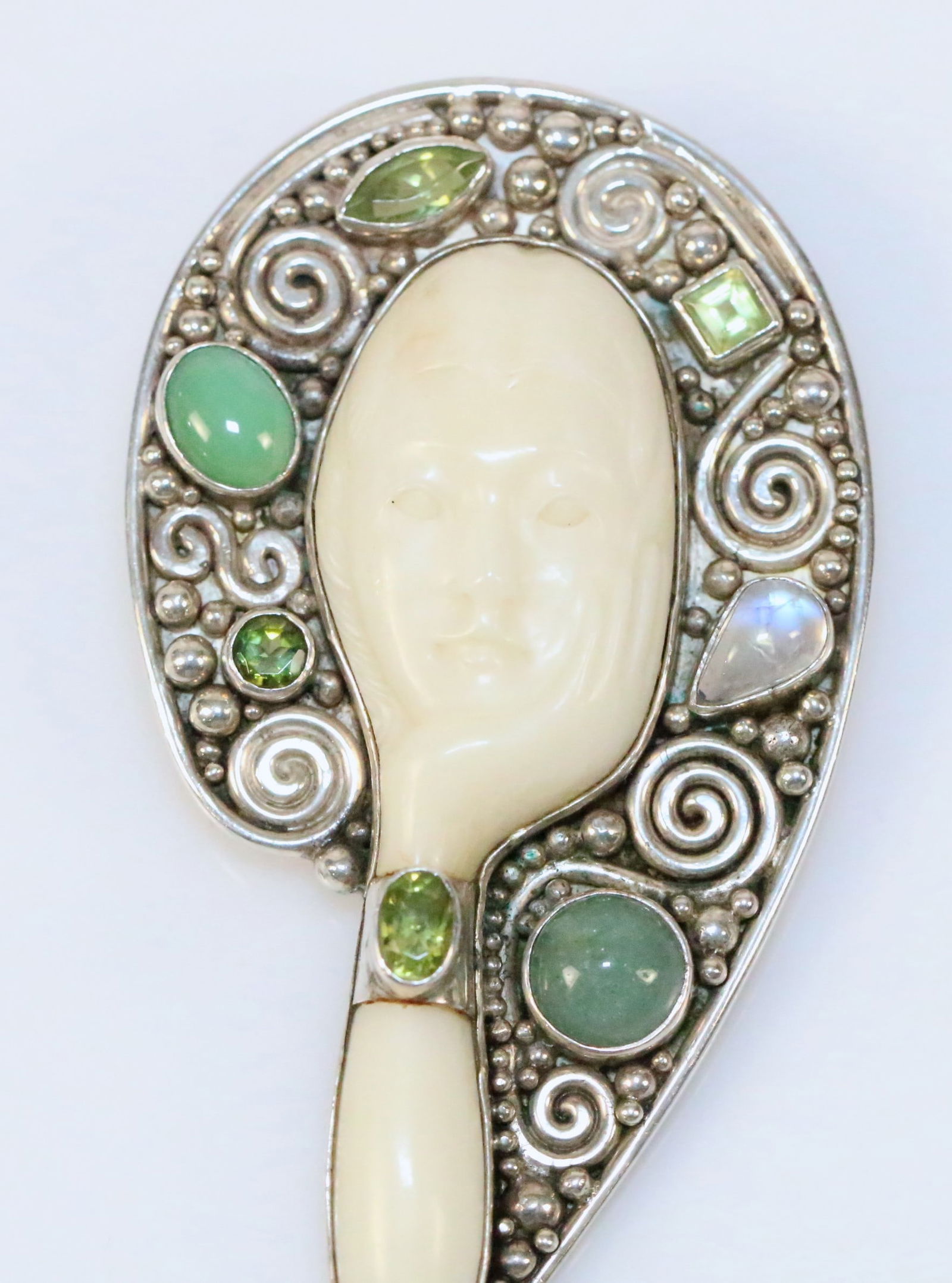 Sajen Huge Carved Woman Goddess Dreamy Sterling Silver Gemstone Brooch Pendant: Magnificent Large Ivory colored bone carving of a lovely woman with her hand cupped under her chin and along the side of her face. Gemstones are moonstone, chrysoprase, & jade set in a wide scroll and