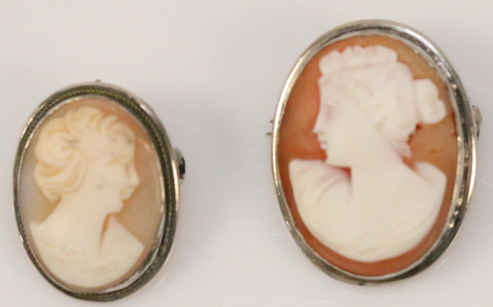 Lot of 2 Antique 800 Silver Cameo brooch pendants: Hallmarked 800 on each. Both have rings for chains. One s missing the pin. One is 1" x 1.25" and is missing the pin. The smaller one is 1" x 3/4"