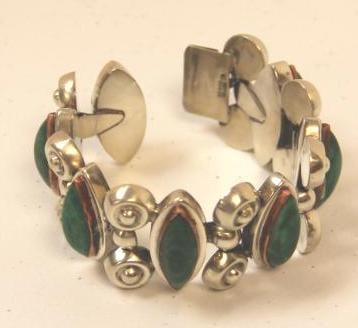 Sterling silver copper malachite bracelet : Malachite set in copper and sterling silver setting bracelet weighs 83.24 grams. Measures: 7" long. X 1.5" wide