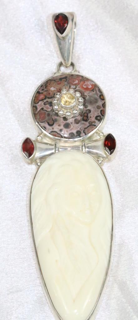 HUGE Sajen Carved Bone Goddess, Garnet gemstone sterling silver pendant: EARLY Sajen HUGE long pendant with ivory bone colored carved goddess with 3 large garnet gemstones, citrines and jasper. Thick solid sterling silver setting. Weighs 56.7 grams. 4.5" long x 1.25" w.