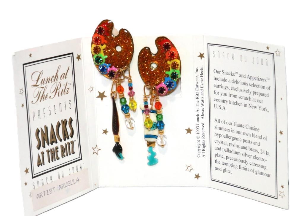 LUNCH AT THE RITZ 24 Kt gold plated Artist Arugula Clip Earrings on card: MADE IN THE USA. Signed Lunch at the Ritz. Beautiful glimmering gold enamel pallete with a rainbow of colors and crystals with artist paint tube on one earring and the paintbrush on the other with 2 s
