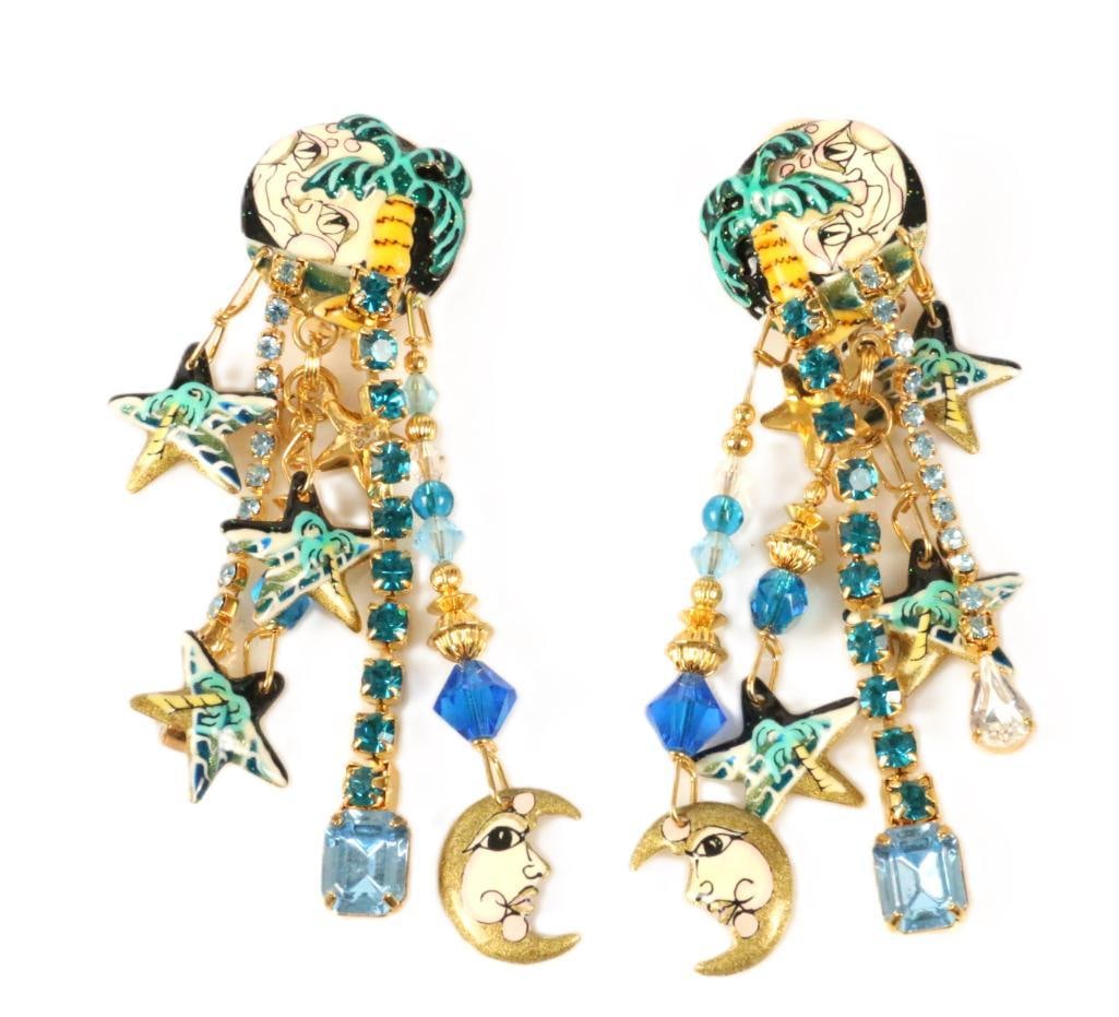 LUNCH AT THE RITZ 24 Kt gold plated Moon Over Miami clip Earrings Stars Celestial: MADE IN THE USA. Signed Lunch at the Ritz. Look new, Tropical palm treen over smiling moon face, with dangling stars, and crescent moon faces dangling. Measure: 1" wide x 3.5" long
