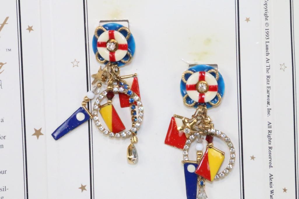 LUNCH AT THE RITZ 24 Kt gold plated Outboard Loops Pierced Earrings Nautical on the card: MADE IN THE USA. Signed Lunch at the Ritz. Nautiful flags, star, life boat ring and loads of brilliant crystals Measure 3" long x approx. 2" wide..