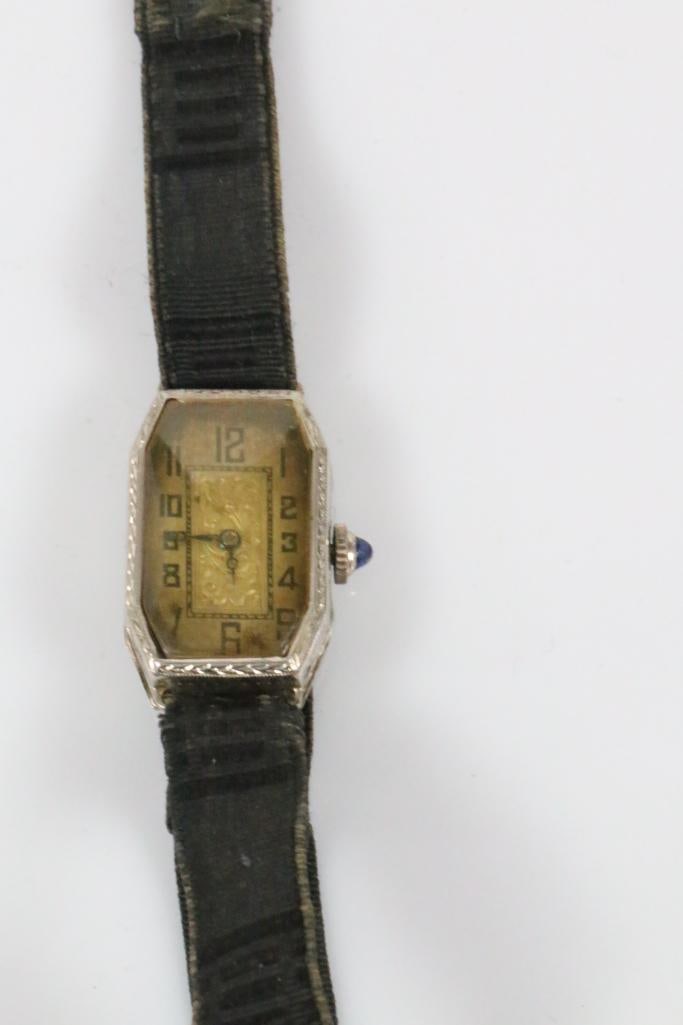 14kt Gold Antique Imperial Watch co. Ladies Victorian Watch: 2 tone - 14kt white gold case and yellow god face. Hallmarked 14kt on the inside of the back case. Etched Victorian scroll design. Gold scroll face. 15 jewels Swiss. Pat pending clasp on original fabr