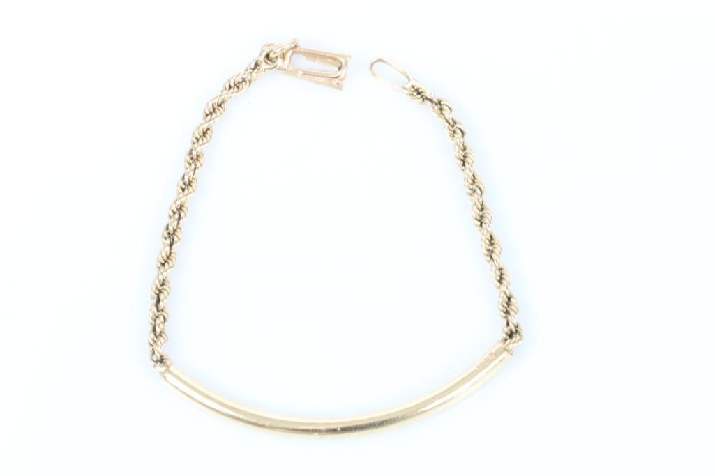 14kt gold Authentic CARTIER Bar Rope Bracelet 10.5 grams.: FABULOUS Authentic Cartier Signed bar and rope bracelet. Measures: 7.5 x 3mm. Bar is hallmarked with the authentic Cartier Signature on one end. The clasps is hallmarked 14kt on each side of the openi