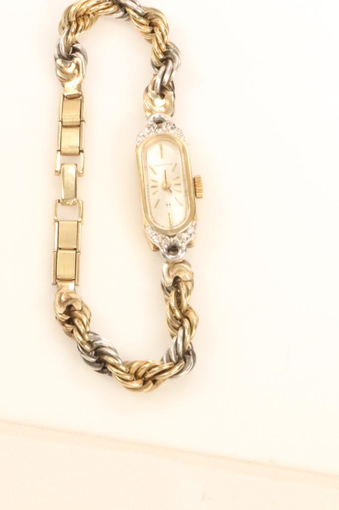 Vintage Hamilton Ladies Diamond Sterling gold filled watch. 17.9 grams: Hamilton Ladies wristwatch. Test for diamond chips. Back is stamped HAMILTON 915878 10kt Gold filled. Chain bracelet is tamped STERLING SILVER and 10kt gold filled.