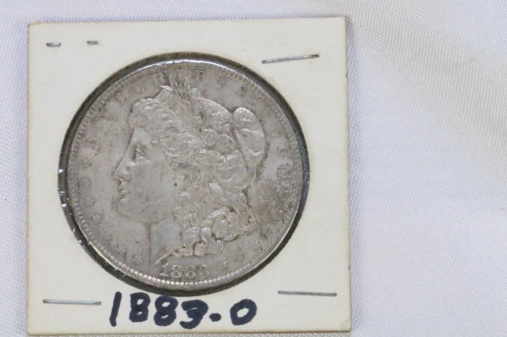 Morgan Silver Dollar in coin protector 1883-0: In cardboard coin sleeve