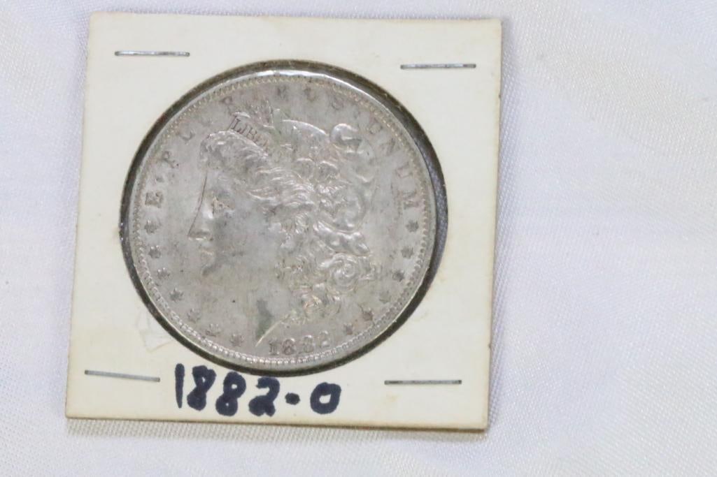 Morgan Silver Dollar in coin protector 1882-0: In cardboard coin sleeve