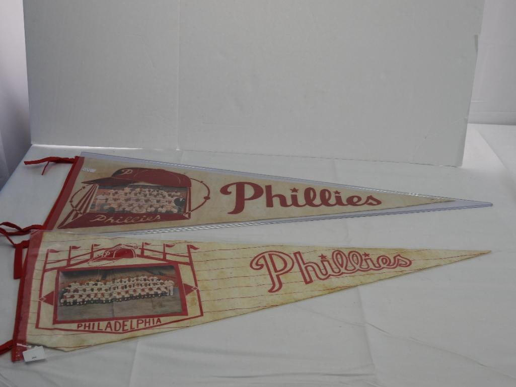 Lot of 2 Vintage Philadelphia Phillies 1960 & 1964 pennants w/ team photos: 30" long, fold in photos, some wear and discoloration due to age, 1 w/ protective sleeve, refer to photos.