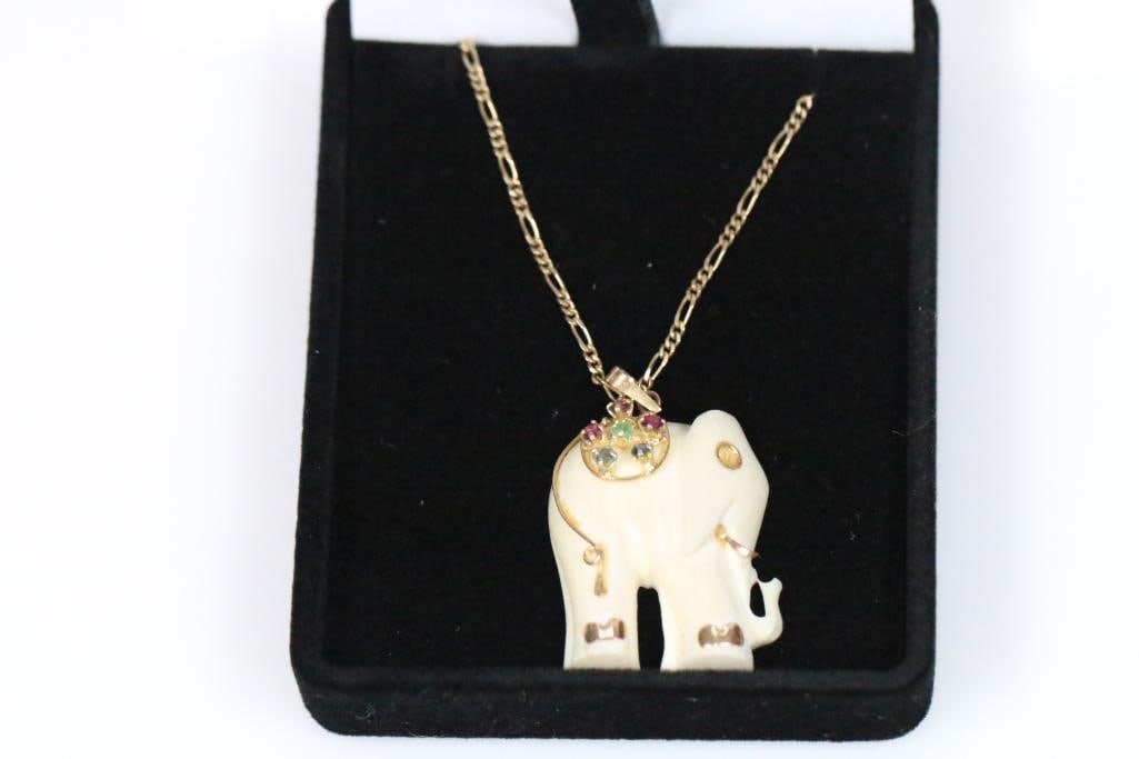 14KT Precious Gems ruby, emerald sapphire Natural Bone Elephant Pendant and Necklace 6 grams: Weighs 6 grams. Beautiful carved Elephant pendant and ivory color bone with 14KT gold accents and harness with prong set emerald, 4 rubies and 2 sapphires color gemstones on a 16: Figaro chain . Chain