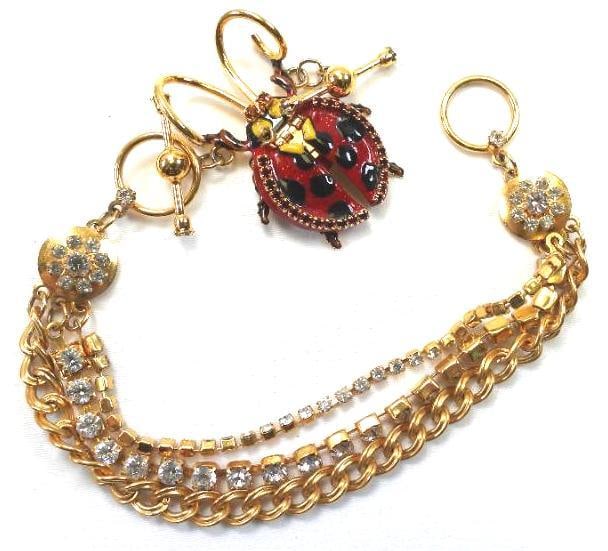 Lunch at The Ritz USA 22KT Gold Plated Bracelet, "Cute and a Bug's Ear": Triple strand toggle bracelet with enameled ladybug made with 22Kt Gold Heavy plating in the USA . Genuine Austrian Crystals. Approx. 9" long