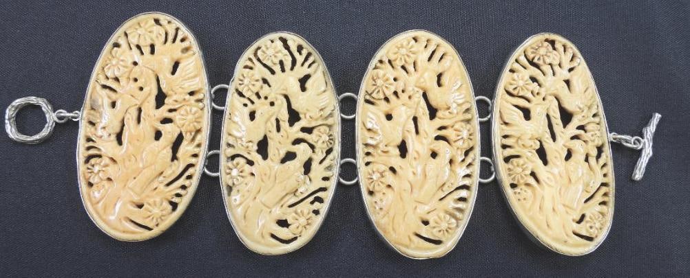 Amy Kahn Russel Sterling Silver Carved Birds, Trees Panel Bracelet: Carved panel bracelet with 4 panels of birds and trees carved in possibly bone, set in sterling silver, 2 7/8"x 8"