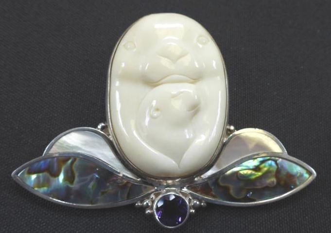 Sajen Sterling silver carved mother and baby seal brooch Pendant: Gorgeous large oval ivory bone carved mother and baby seal with abalone, mother of pearl and amethyst 2.75" w x 2"h.