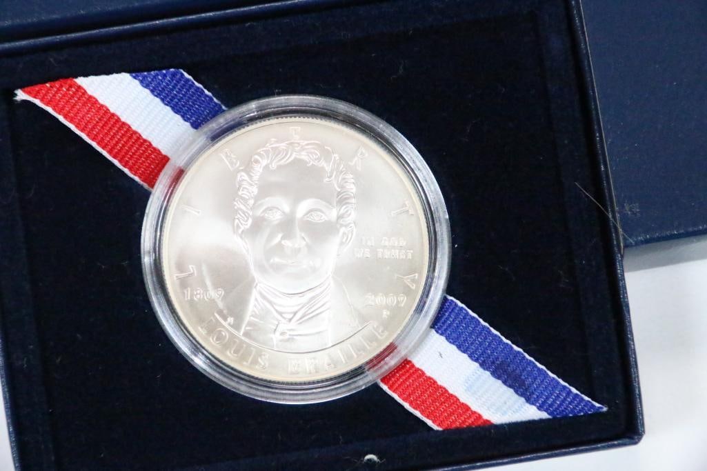 United States Mint 2009 Louise Braille Bicentennial Proof Silver Dollar: Numismatic Silver Dollar Coin in the UNITED STATES MINT encased in clear plastic in a cardboard box and outer cardboard sleeve with COA. PLEASE See pictures for Details of coins in each set including 