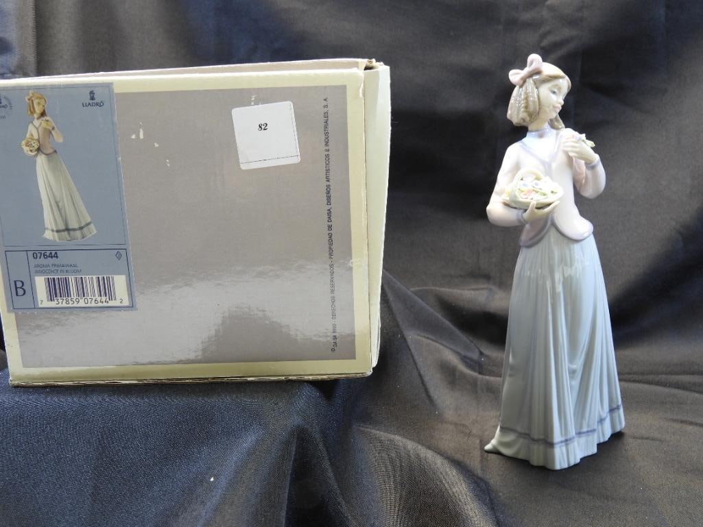 LLADRO Porcelain Figurine, "Innocence In Bloom" 1996, SIGNED, NUMBERED, BOXED: Lovely and detailed porcelain figurine of a young girl with a basket of flowers, 9.75" tall, dated 1996, "Innocence in Bloom"; Made in Spain, the figurine showcases the beautiful and delicate glossy t