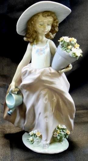LLADRO Porcelain Figurine, "A Wish Come True" 1999 , SIGNED, NUMBERED, BOXED: Lovely and detailed porcelain figurine of a young girl with flowers, dated 1999, approximately 9.5" tall, Made in Spain, the figurine showcases the beautiful and delicate glossy transparent glazes Lla