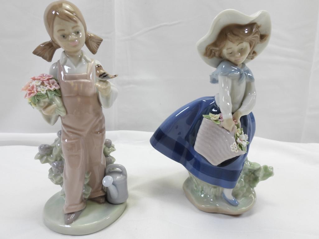 LOT OF 2 LLADRO Porcelain Girl Figurines: Lovely and detailed lot of 2 porcelain figurines, 1983 girl with flowers and a bird, 7.5", and 1983 girl with a basket of flowers, 7" tall; made in Spain, the figurine showcases the beautiful and deli