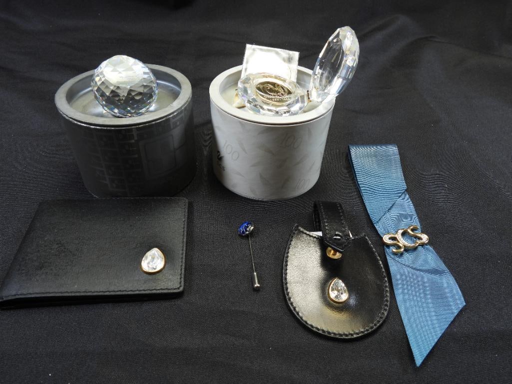 LOT OF 7 SWAROVSKI Austrian Crystal Swarovski Society Awards: Lot includes a paperweight, a SIGNED crystal box, (2) 100th anniversary coins, a wallet, a pouch, a pin, and a tie pin