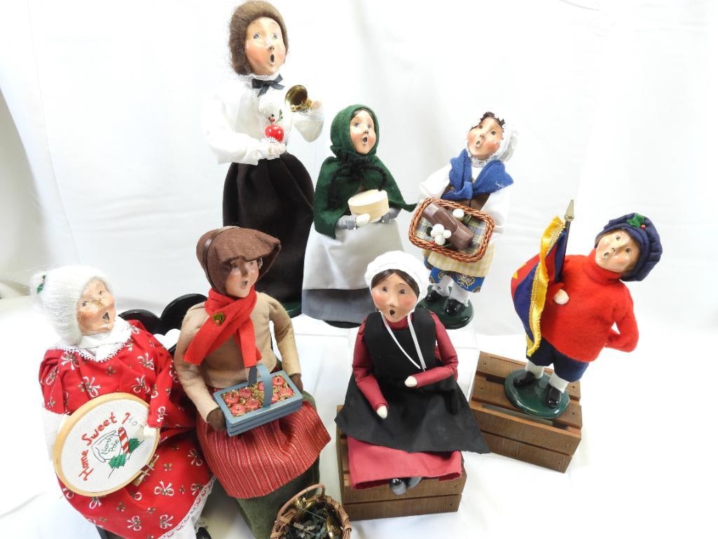 LOT OF 7 BYERS CHOICE Carolers: An amazing lot of 7 Byers Choice carolers; 1993 (12.5") Teacher, 2000 seated lady, 2003 lady with Buche de Noel (9.25"), 1997 flag boy (9.25"), 1997 girl with box (9.25"), seated lady with apples, and