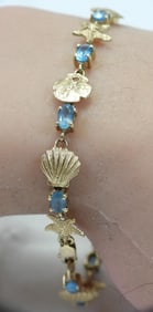 14kt gold and aquamarine gemstones sea shell bracelet star fish, sand dollar scallop 6.9 grams