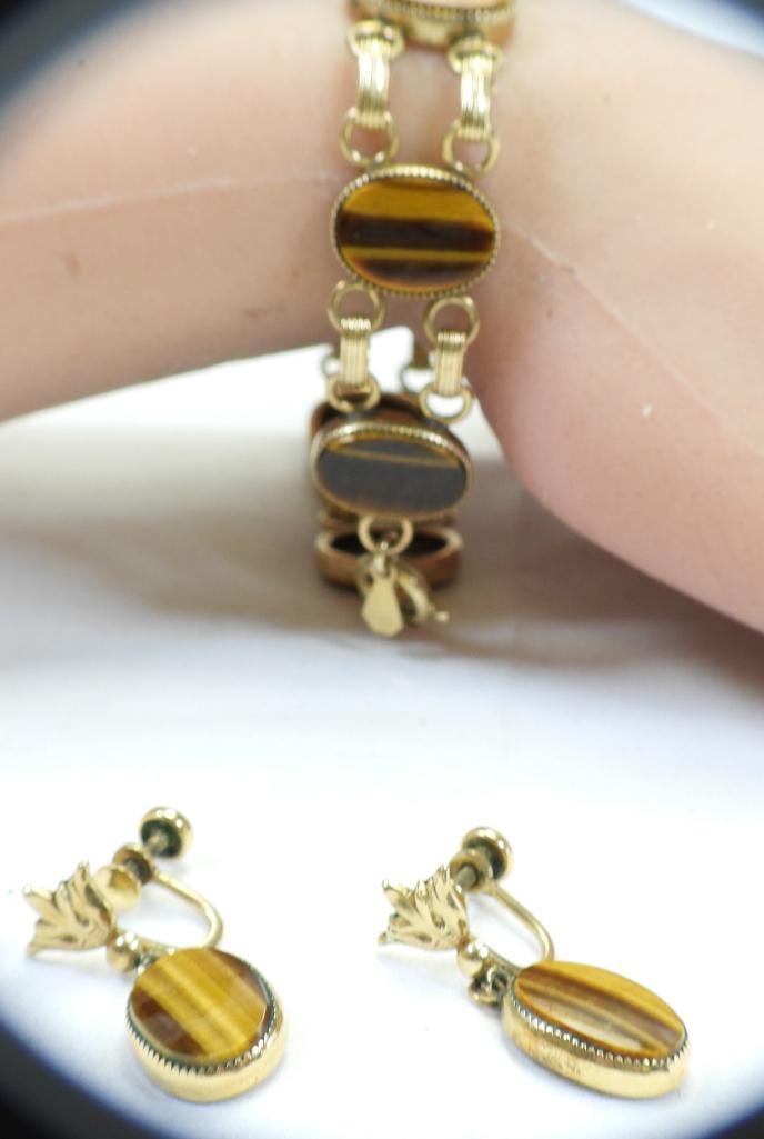 AMCO Vintage 12 KT Gold filled tiger eye bracelet and earrings set 18.5 grams: Vintage lovely set in excellent condition. Textured oval setting. Screw back earrings 1" drop. Bracelet measures 7.5" x 1/2" wide .