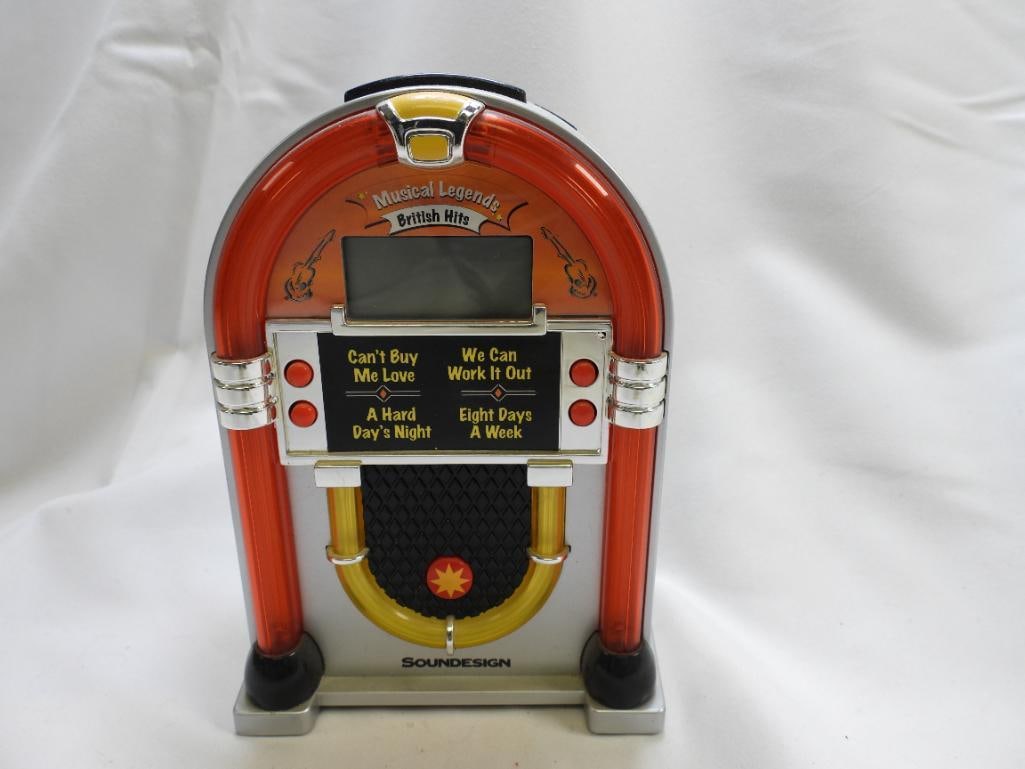 A Beatles Jukebox Battery Operated Alarm Clock by Soundesign: A Beatles jukebox battery operated Alarm clock by Soundesign, approximately 6.5" tall, function not tested