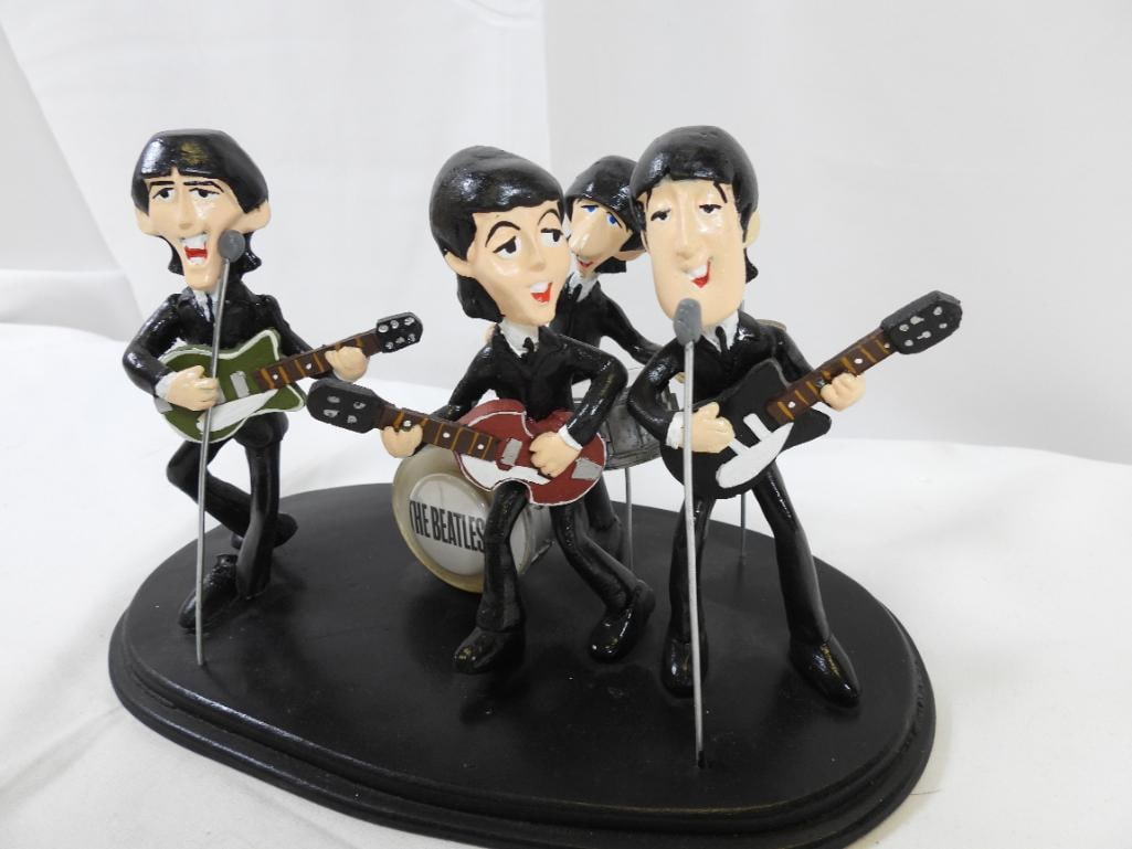 Beatles Band Performing Resin Display: A resin display of The Beatles performing, approximately 5.25" tall x 9" long; damage noted to Goege Harrison figure