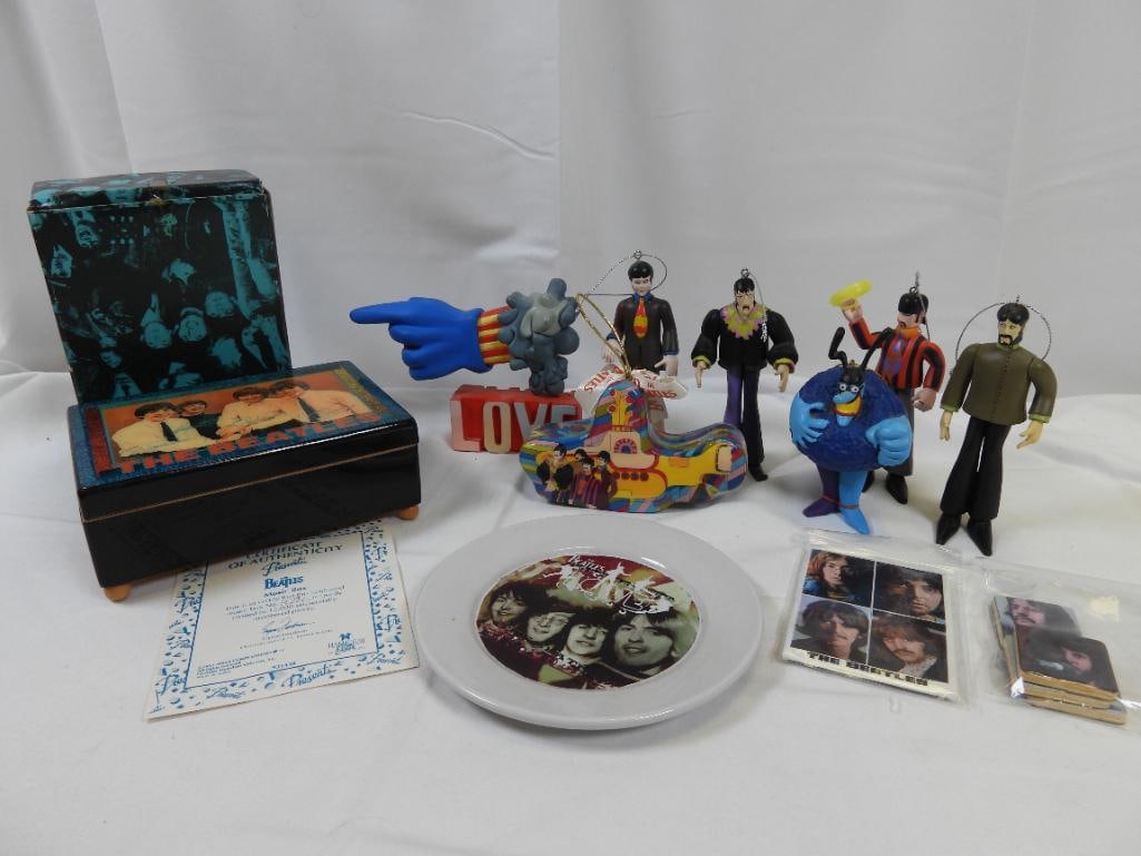 LOT OF 11 Beatles Items Including Music Box, Ornaments, and MORE: Lot includes a working wooden music box that plays "All My Loving", numbered with certificate of authenticity, a 5.88" plate, magnets, McFarlane Toys "Hand", and 6 ornaments