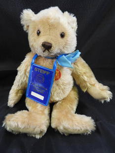 Vintage STEIFF 13" teddy bear: Vintage STEIFF approx. 13" tall teddy bar with light blue ribbon and STEIFF ear button, may have discoloration due to age, overall clean.