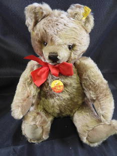 Vintage STEIFF 14" teddy bear: Vintage STEIFF approx. 14" teddy bar with red ribbon with original tag and STEIFF ear button, moveable joints so can stand freely, may have discoloration due to age, overall clean.