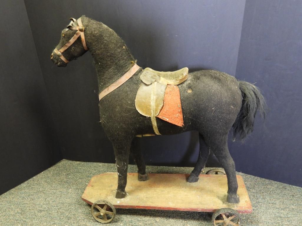 Vintage 21" tall horse on wheels: Vintage approx. 21" tall horse on wheels, one wheel missing. See pictures for wear due to age