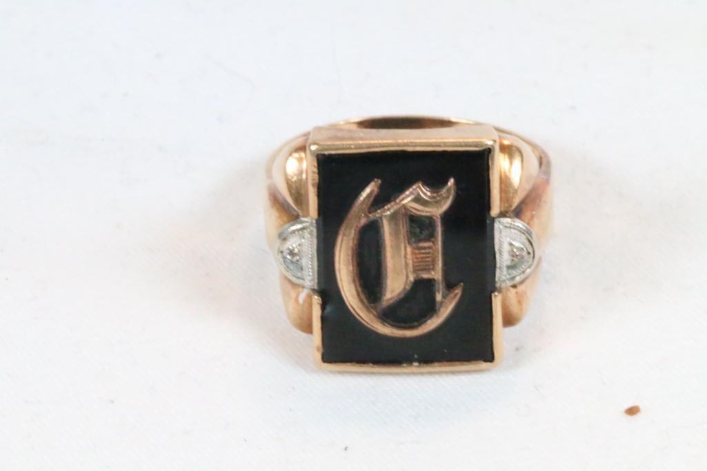 10Kt Gold Onyx and diamond insignia ring 5.3 grams Size 9: Black onyx with gold insignia and a single full count round diamond on each side. Approx 2mm round