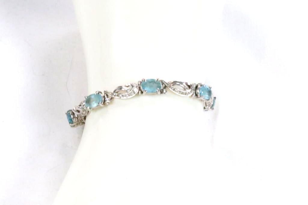 18kt White Gold Aquamarine & diamond bracelet 15.6 grams.: Bracelet measures: 6.5" long . Hidden locking clasp . Bracelet features: 7 aquamarine gemstones measure approx. 8.5mm x 6.6 mm. plus 49 full cut diamonds approx. 2mm each, slightly varying .