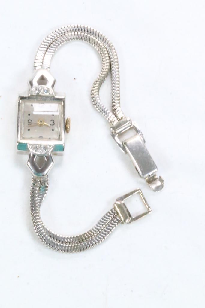 14KT White Gold & diamond Ladies Watch and band Maker FELCA. 19.7 grams.: Measures: 6.5" long Band width 5.3 mm (2 strand bracelet band)Watch case is hallmarked 14k. Etched in the back "To Claire with all my love JOE". Double chain band also hallmarked 14K