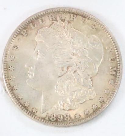 1898 Morgan Silver Dollar Coin: In plastic sleeve. See photo for details. Nice details LIBERTY is legible.