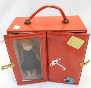 Antique doll in locking storage case and clothes