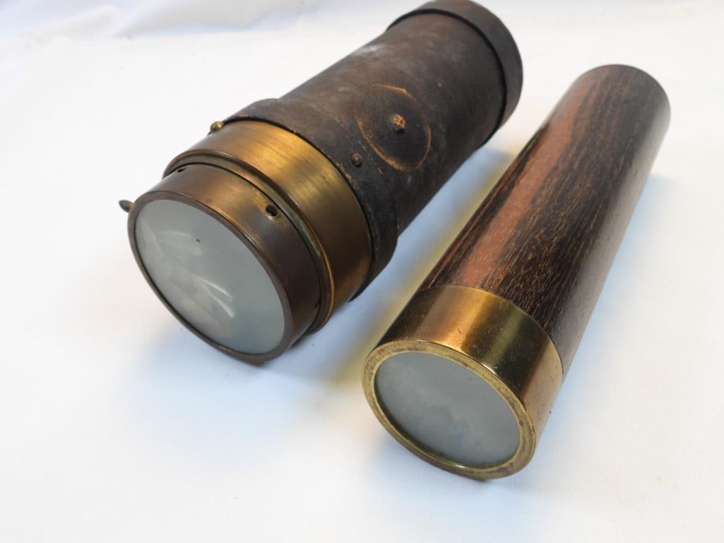 Pair of antique kaleidoscopes. Leather and wood: Pair of vintage kaleidoscopes, one is 9.25" approx. in length and other is 9.75 approx. in length. Larger leather one has broken glass inside. exterior intact. Smaller wood one is intact.