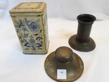 Vintage tin can, brass inkwell, and candleholder