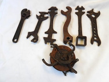 LOT OF 7 antique cast iron tools including a pulley and wrenches