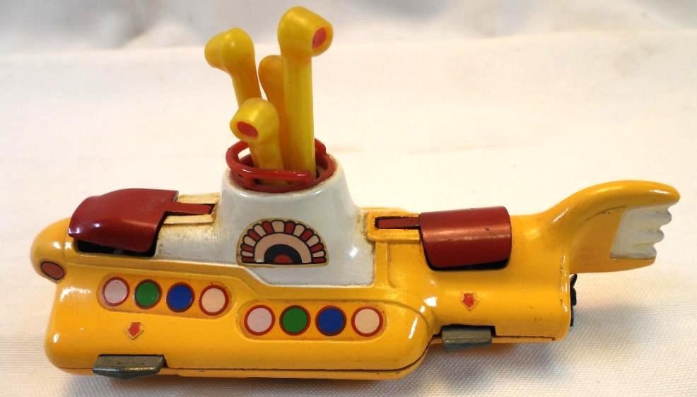 Corgi YELLOW SUBMARINE die-cast toy with BEATLES inside: Corgi YELLOW SUBMARINE die-cast toy with BEATLES inside, buttons don't make red covers lift but can be manually opened, approx. 3" tall and 5" long