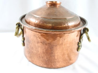 Vintage copper pot with a lid and what appears to be brass handles