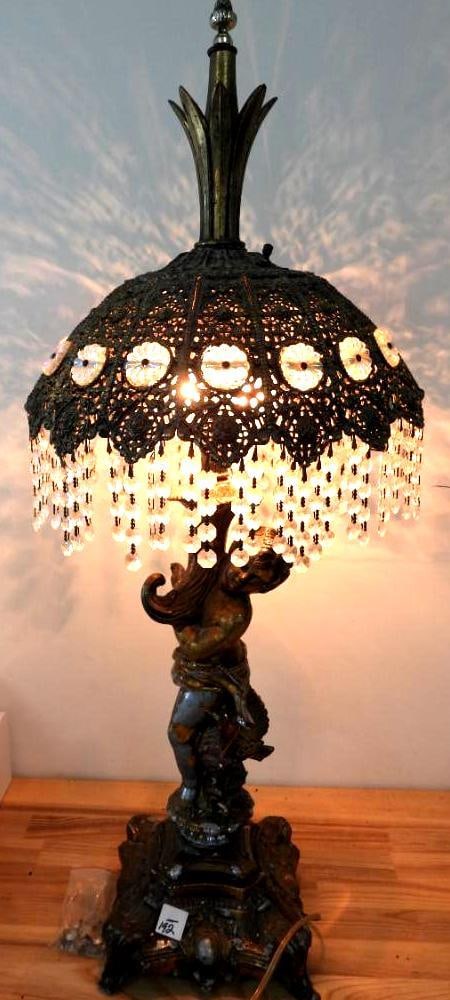 Antique guilded metal Hollywood Regency-style table lamp with cherub & crystals.: Hollywood Regency-style table lamp with cherub, 35"T, 13"W shade and 8"W base. there may be a few missing crystal strands. Hard to notice.