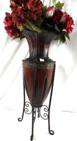 Tall brown metal vase with built-in stand