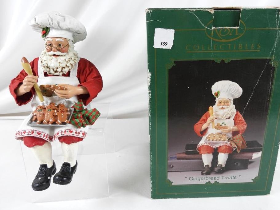 KSA FABRICHE KURT ADLER "Gingerbread?" W6214: KSA FABRICHE KURT ADLER "Gingerbread Treats" Santa sitting with gingerbread cookies (can sit on mantle or another item), full resin. W6214. In original box. 10"Tx5"Lx5"W