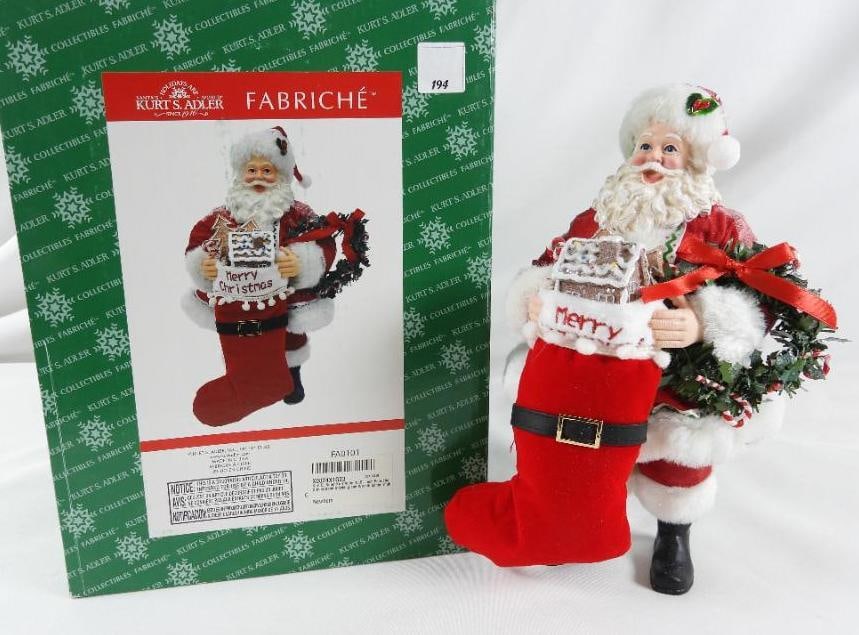KSA FABRICHE KURT ADLER Santa, solid resin: KSA FABRICHE KURT ADLER Santa holding Merry stocking with gingerbread house and a wreath, solid resin, FA0101, in original green box. Dimensions: 12"Tx6.5"Lx5"W
