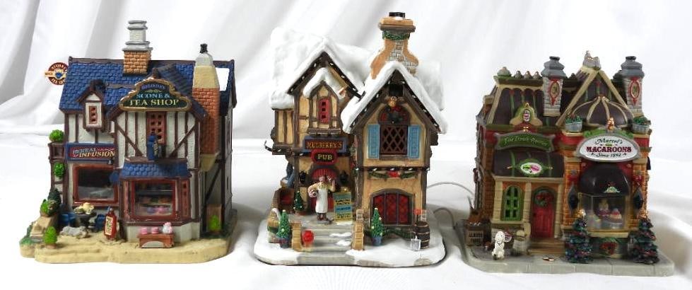 LOT OF 3 LEMAX including Mulberry's Pub: LOT OF 3 LEMAX displays in styrofoam from original boxes: 2018 Marcel's Macaroon's, 6.5"Lx5.25"Wx7"T, Mulberry Pub (Lighted, not tested), 6"Lx5.5"Wx8.5"T, and Melinda's Scone & Tea Shop, 6.5"Lx6"Wx8.5