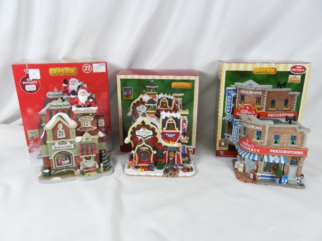 LOT OF 3 LEMAX lighted pharmacy, etc. in boxes: LOT OF 3 LEMAX lighted shops: Albee's Pharmacy #75516, 6"Lx5"Wx7.5"T, St. Nick's Elf Academy, #95530, 7.5"Lx5.5"Wx8"T, and The Santa Shop, #35039, 7"Lx5"Wx9"T