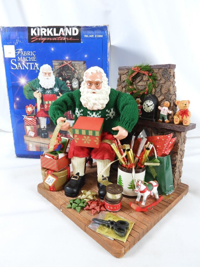 KIRKLAND FABRIC MACHE Santa #212206, original box: KIRKLAND FABRIC MACHE Santa #212206, in original box, wrapping presents near fireplace with container of wrapping paper, 7.5"Lx8"Wx9"T