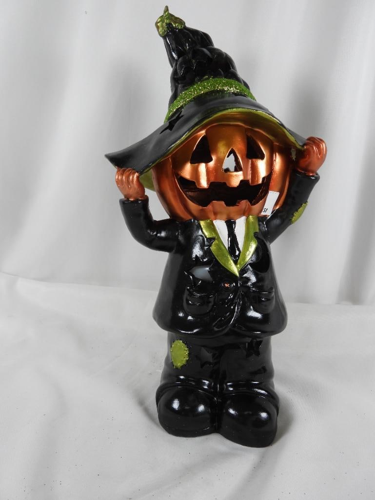 Hay & Harvest illuminated Pumpkin Spirit: Hay & Harvest Medium Resin pumpkin man in suit and tie illuminate by faux candle in the center and takes 2C batteries in the bottom also covered by plastic NOT TESTED (recommended for porch use only)