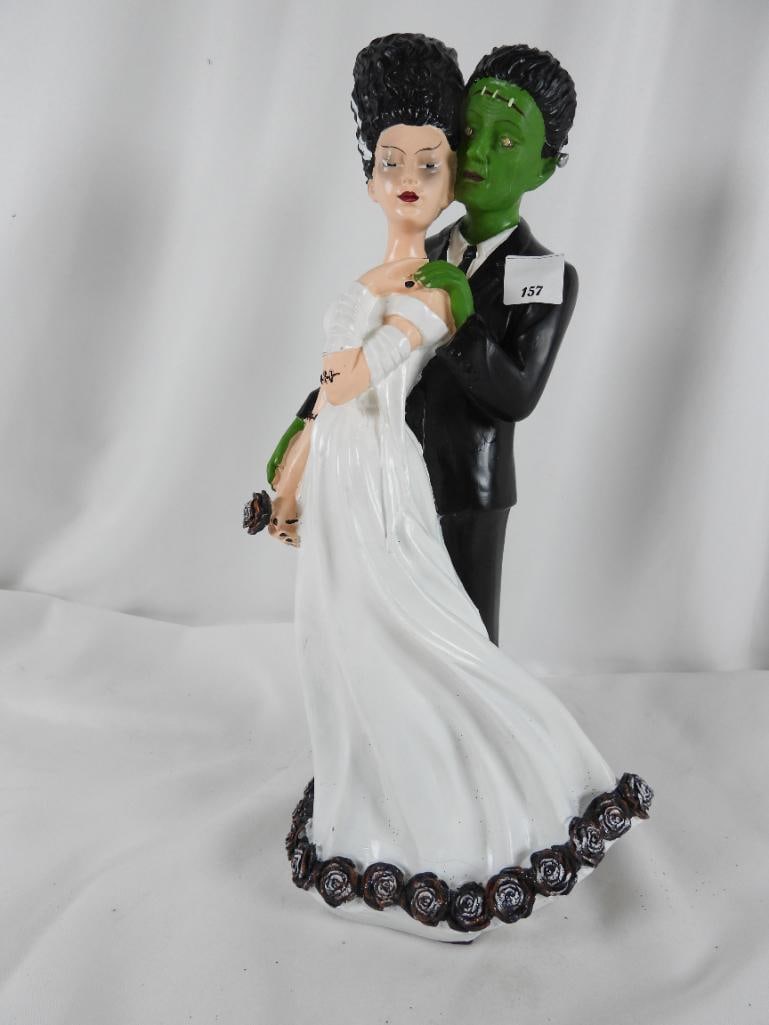 Medium Resin Bride of Frankenstein: Bride of Frankenstein illuminates through Frankenstein monsters eyes and takes batteries in the bottom of the piece (dress has slight crack in the front) possible CR2032 or CR2025 not in cluded NOT TE